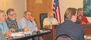 With a briefing from deputy civil prosecutors Jon Cain (right) and Amy Vira (not pictured)