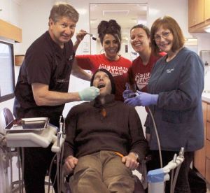 Dental team volunteers give this Fish for Teeth patient the royal treatment. From left