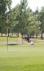 Jeff MacDonald hits his ball out of the sand trap on the 9th hole Saturday in the Two-Man Best Ball Tournament at San Juan Island Golf and Country Club. MacDonald shot par on the hole and