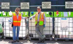 Volunteers Julie Van Camp and Mac Langford stand by at the recycle component of the award-winning Lopez Solid Waste Disposal District.
