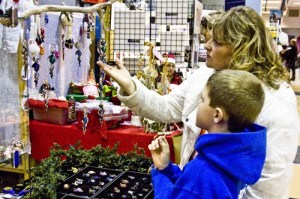 Two islanders admire glass art at Joseph Crisanti’s booth. Over 50 vendors from all four islands gathered on San Juan Island to offer an array of items at the Artisans Holiday Market.