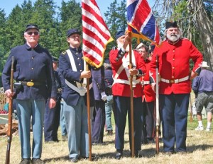 Pig War-era re-enactors prepare to present colors at Encampment 2012.