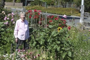 Edith Dickenson standing in her garden.