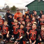 Little league football teams win championship trophies