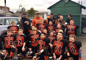 Little league football teams win championship trophies