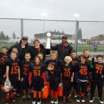 Little league football teams win championship trophies