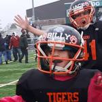 Little league football teams win championship trophies