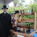 Staff photo/Hayley Day                                Hawke Pingree of San Juan Island Distillery sells drinks at Brickworks Old-Fashioned Christmas Market.