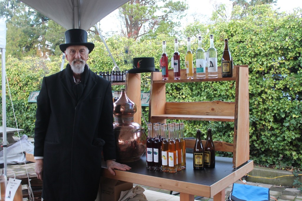 Staff photo/Hayley Day                                Hawke Pingree of San Juan Island Distillery sells drinks at Brickworks Old-Fashioned Christmas Market.