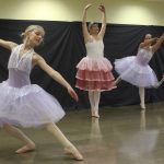 Staff photo/ Hayley Day                                Anabelle Mountford dances the Waltz of the Flowers, as Regina Kammer and Eleanore Rollins pose behind.