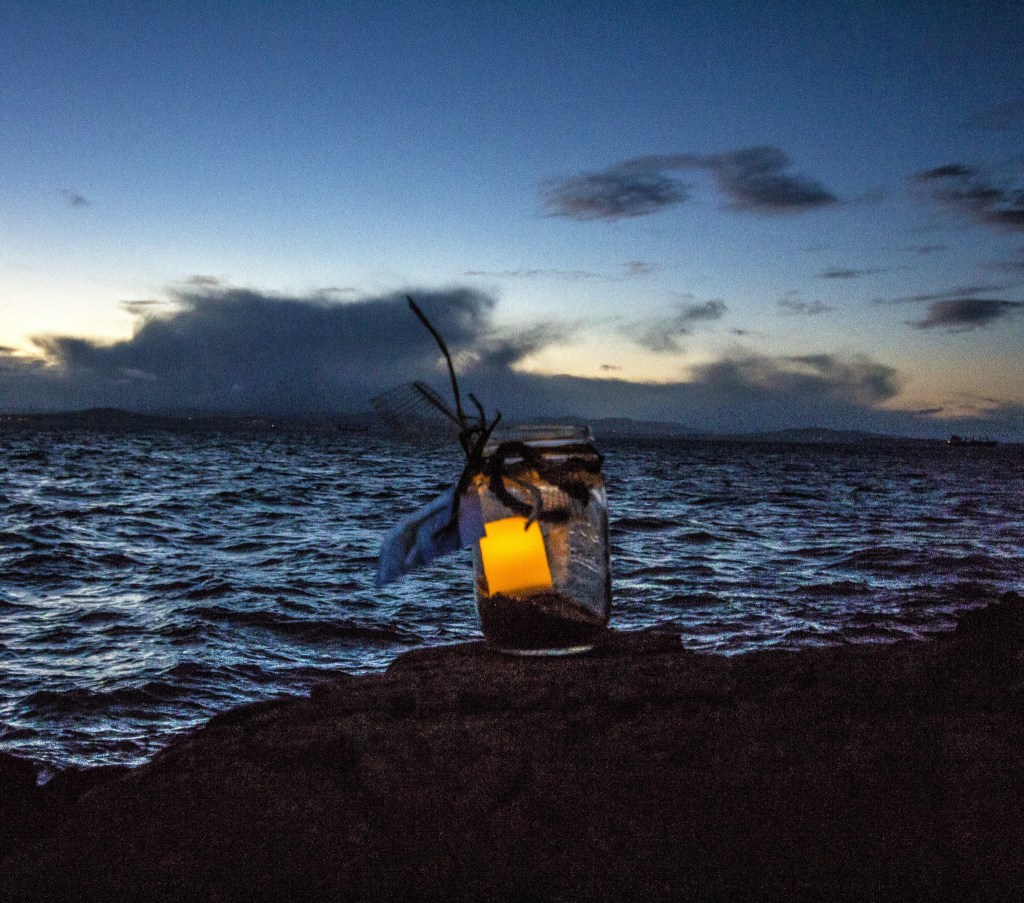 Staff photo/Greg Sellentin                                Battery-powered tea lights were placed in glass jars for the windy evening.