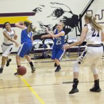 Staff photo/Greg Sellentin                                Alexa Mora bounce passes under the hoop to Hayden Mayer.
