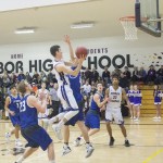 Staff photo/Greg Sellentin                                From left to right: Sophomore Marshall Clark wrestles a rebound and scores from under the hoop; senior Eli Cooper-West makes memorable breakaways and layups; senior John Gustafson has a strong second half.
