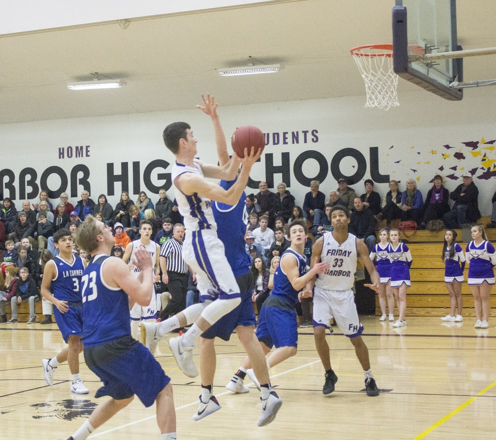 Staff photo/Greg Sellentin                                From left to right: Sophomore Marshall Clark wrestles a rebound and scores from under the hoop; senior Eli Cooper-West makes memorable breakaways and layups; senior John Gustafson has a strong second half.