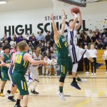 Staff photo/Greg Sellentin                                John Gustafson hits a two-point shot from under the basket under strong defense.
