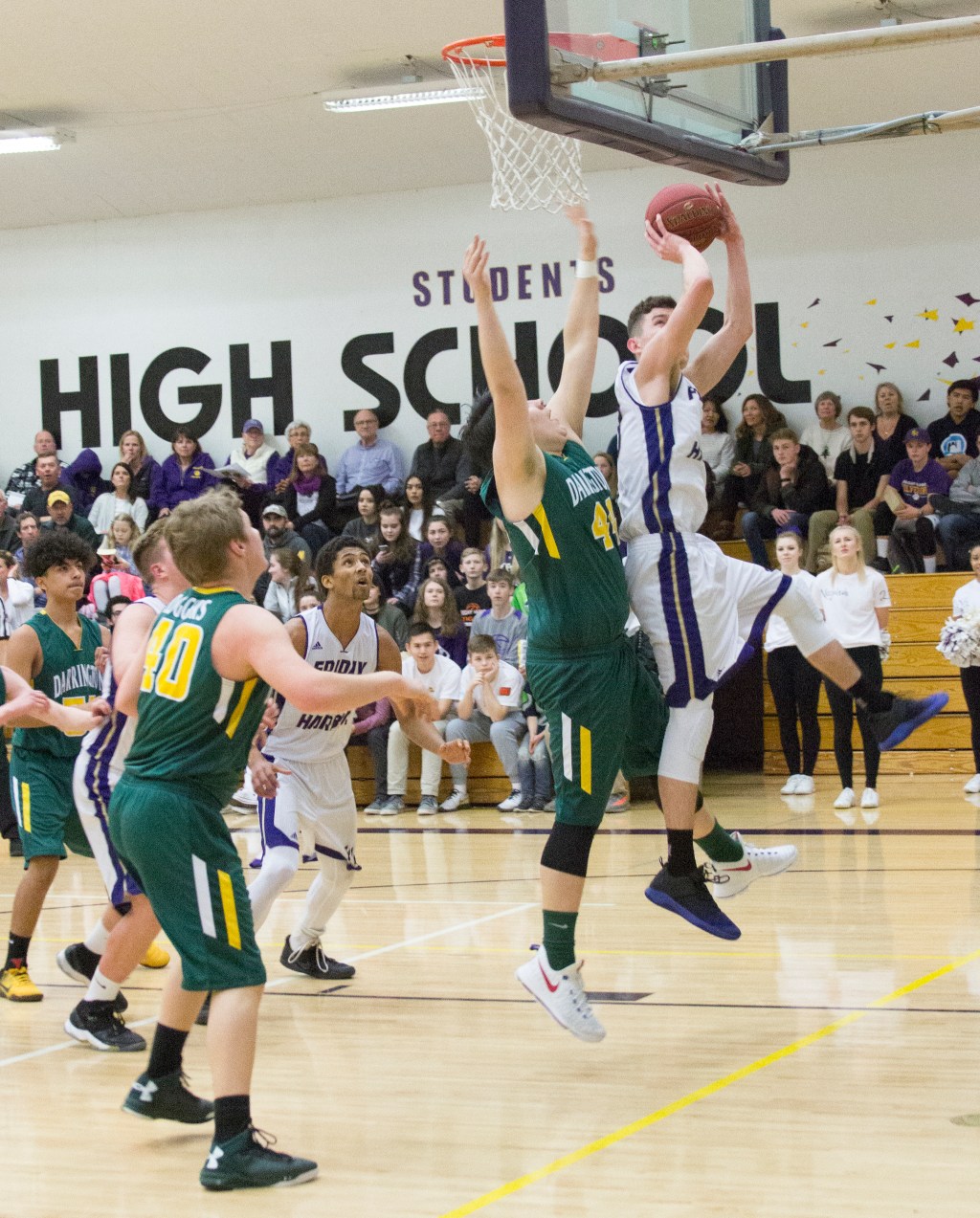 Staff photo/Greg Sellentin                                John Gustafson hits a two-point shot from under the basket under strong defense.
