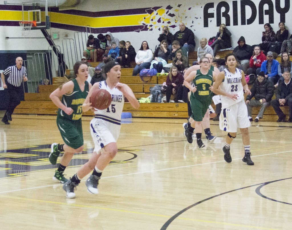 Staff photo/Greg Sellentin                                Kiana Woods brings the ball down court.