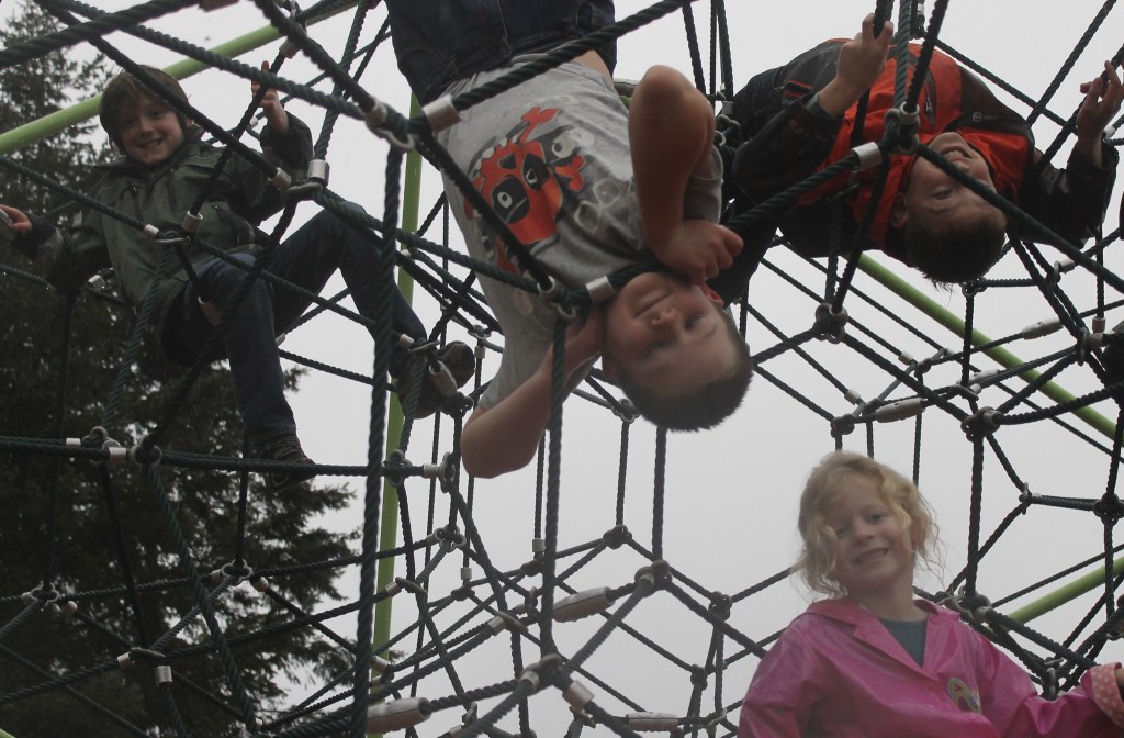 Staff photo/Hayley Day                                Kids from Island Rec&rsquo;s Winter Break Camp hang from a spider dome at the John O. Linde Park&rsquo;s new playground on Dec. 29.