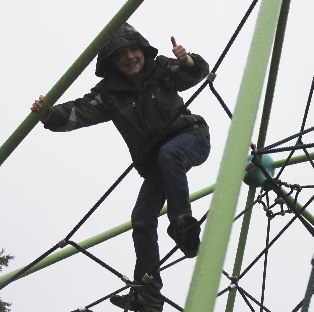 Staff photo/Hayley Day                                Fourth grader Kieran Cochran gives a thumbs up from a spider dome at the John O. Linde Park&rsquo;s new playground on Dec. 29.