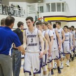Staff photo/Greg Sellentin                                Senior Eli Cooper-West leads the Wolverines in congratulating the opponents after the game.