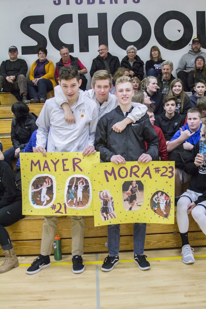 Staff photo/Greg Sellentin                                Senior basketball star John Gustafson and Wolverine wrestler James Guard stayed around after the game to support the girls&rsquo; team.