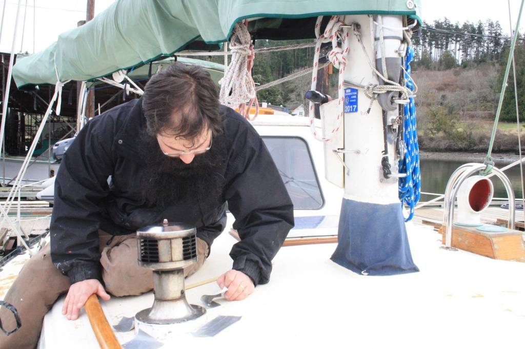 Staff photo/Hayley Day                                Nate Hertel fixes a boat deck at Albert Jensen and Sons Boat Yard and Marina on San Juan Island. Hertel learned boat repair while in the U.S. Coast Guard.