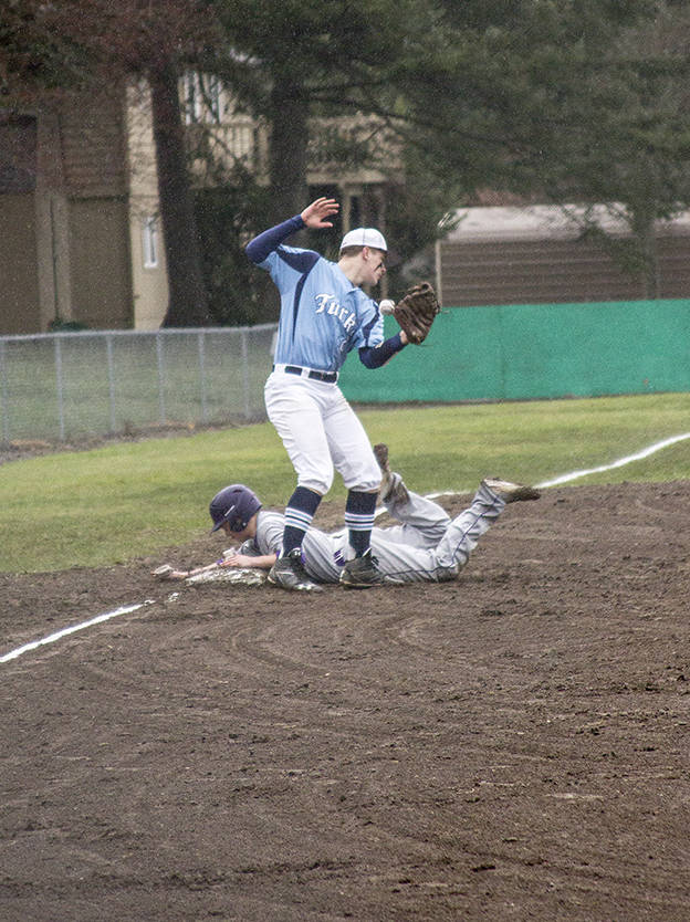 Staff photo/Greg Sellentin                                Nick Herko slides into third base safely.