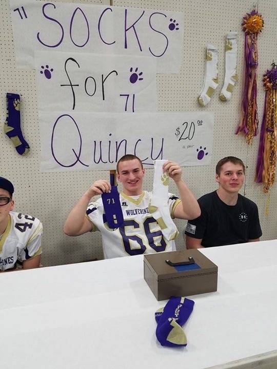 Contributed photo/Stacey Smith                                Christine Minney&rsquo;s son personalized socks to raise money at the fundraiser &mdash; one with Quincy&rsquo;s name and the other with his football jersey number.