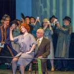 Billy Flinn (Bo Turnage) speaks for Roxie Hart (Amanda Smith) to the press