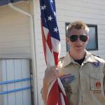 Staff photo/Hayley Day                                Chris Hallock, a high school senior, prepares to march with the boys scouts in the parade.
