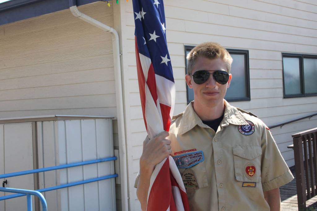 Staff photo/Hayley Day                                Chris Hallock, a high school senior, prepares to march with the boys scouts in the parade.
