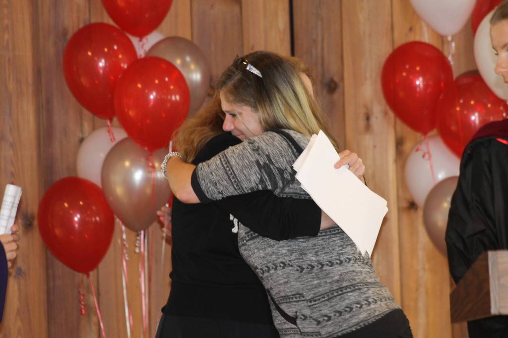Staff photo. Marine Tech graduate hugs EDC director Victoria Compton.