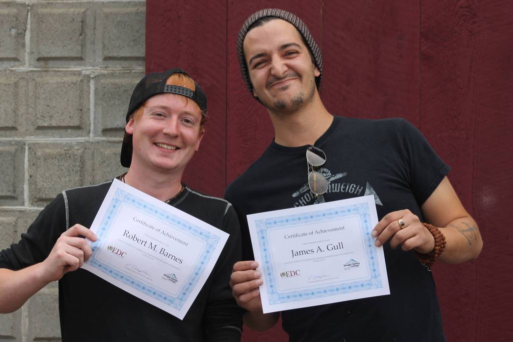 Staff photo. marine Tech graduates Robert Barns and James Gull show off their certificates.