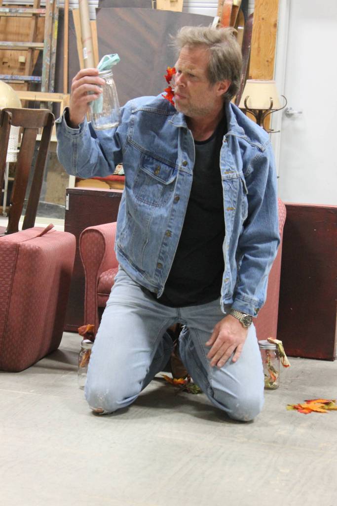 Staff photo/Heather Spaulding. Brad Fincher, as Chris, finds a Molotov Cocktail in &ldquo;Velocity of Autumn.&rdquo;                                Staff photo/ Heather Spaulding. Brad Fincher and Deb Langhans rehearse as Chris and Alexandra in &ldquo;Velocity of Autumn.&rdquo;