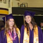 Staff photo/Heather Spaulding                                Graduates in caps and gowns walk toward the podium.