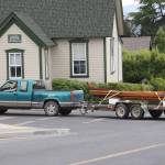 Staff photo/Hayley Day                                Malcolm Suttles drives a 125-foot canoe through town on Monday, July 10.