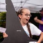 Contributed photo/Amber Chenoweth Photography                                London Fletcher shows off the orca fin she won in the live auction.