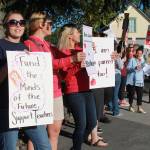 Staff photo/Hayley Day                                Teachers hold signs requesting fair contracts in front of Wells Fargo on the corner of Spring Street and Argyle Avenue on Sept. 1.