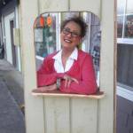 Contributed photo/Evelyn Eaglesong                                Evelyn Eaglesong poses in her new ticket booth outside for the theater.