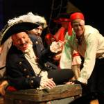 Staff photo/Heather Spaulding                                Staff photo, Heather Spaulding. Black Stache, played by Craig Nett, on his treasure, with a pirate played by Brad Fincher behind him.