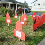 Staff photo/Tate Thomson                                Each red silhouette tells the story of a Washingtonian who passed away from domestic violence in 2016.
