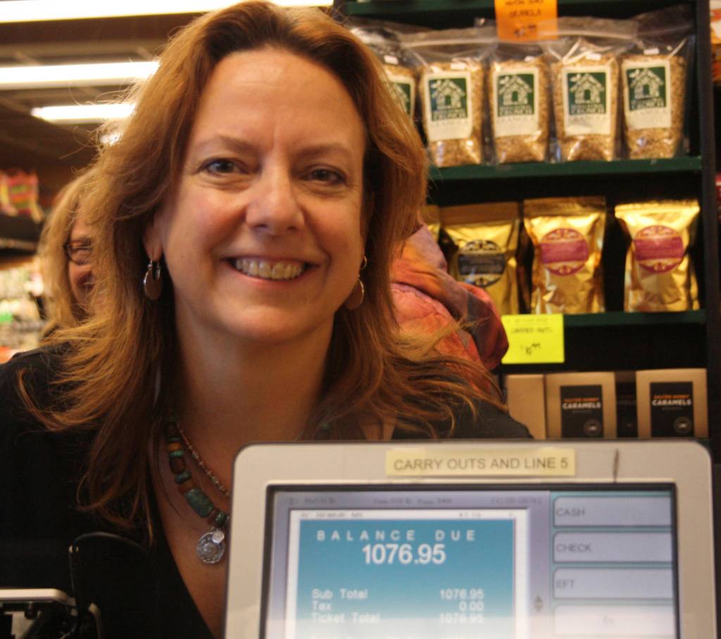 Staff photo/Hayley Day                                Shahn McGuire smiles as the groceries are tallied  a total of $1,076.95.