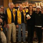 Staff photo/Hayley Day                                Shahn McGuire and San Juan Lions Club members gather in front of the collected items after the spree.