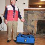 Staff photo/Heather Spaulding.                                Red Cross volunteer Bill Severson demonstrates a to go bag.