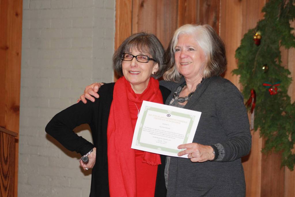 Staff Photo Heather Spaulding. Becki Day presents the award for best Utilities to San Juan Wireless