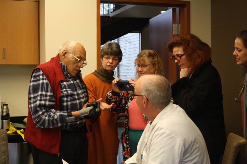 Staff photo/Hayley Day                                Staff and guests view Lyle Manns bionic hand at Peace Island Medical Center on Dec. 28.