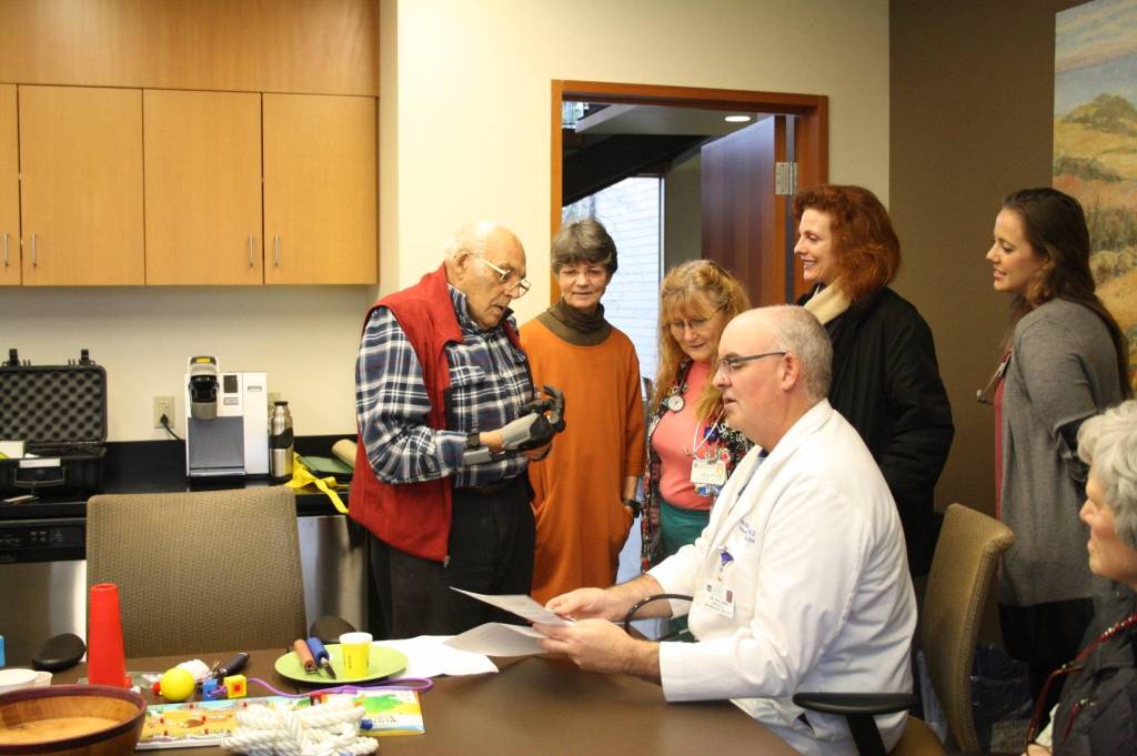 Staff photo/Hayley Day                                Staff and guests view Lyle Manns bionic hand at Peace Island Medical Center on Dec. 28.
