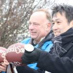 Staff photo/Hayley Day                                Footballs for the projects Most Valuable Players were given to OPALCO Engineer Joel Meitzner and Keizo Takeo of Sumitomo Electric.