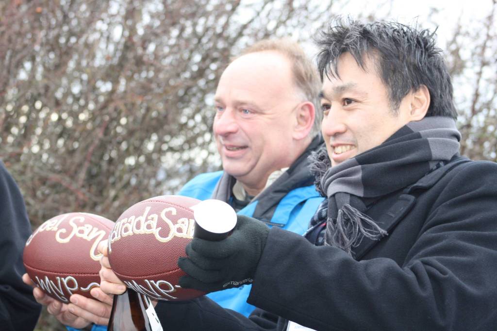 Staff photo/Hayley Day                                Footballs for the projects Most Valuable Players were given to OPALCO Engineer Joel Meitzner and Keizo Takeo of Sumitomo Electric.