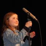 Staff photo/Heather Spaulding                                Participant April Cain adjusts the mic.